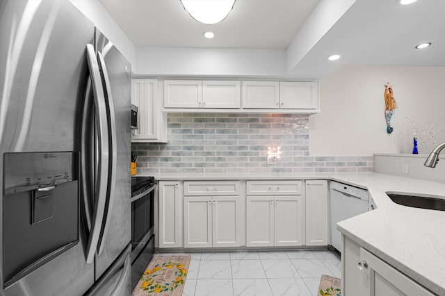 kitchen with black electric range oven, white cabinets, sink, light stone countertops, and stainless steel fridge with ice dispenser