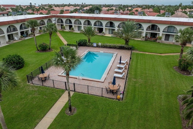 view of swimming pool with a patio area and a lawn