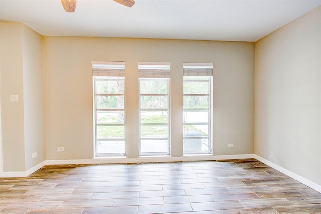 unfurnished room with a wealth of natural light and wood finish floors