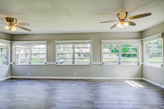 unfurnished sunroom featuring a wealth of natural light and a textured ceiling
