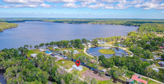 birds eye view of property with a water view and a residential view