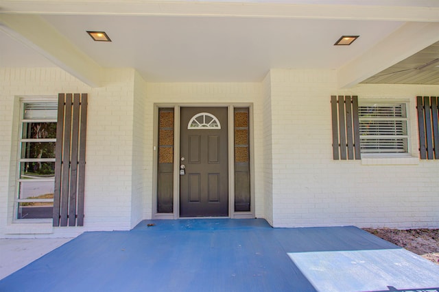 property entrance featuring brick siding
