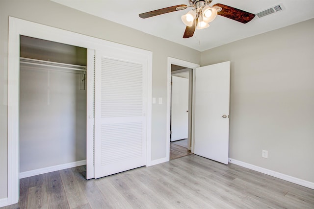 unfurnished bedroom with a closet, ceiling fan, light wood-style flooring, baseboards, and visible vents