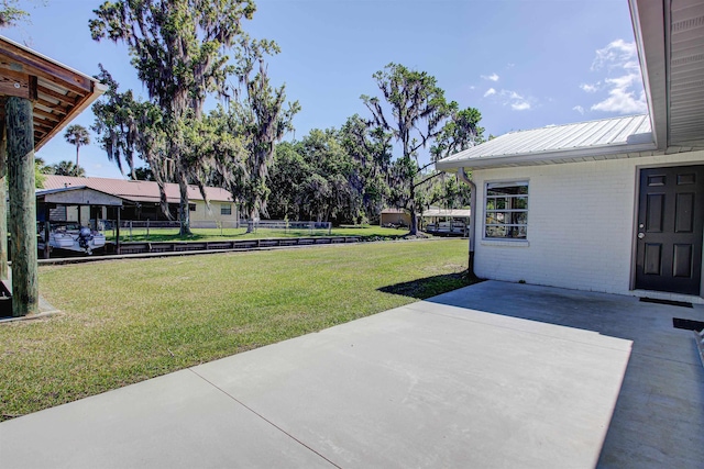 view of yard featuring fence and a patio