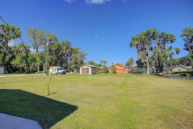 view of yard with an outbuilding and a shed