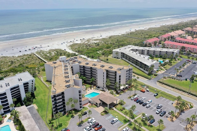 birds eye view of property featuring a view of the beach and a water view