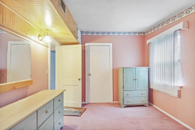 interior space with light carpet and a closet