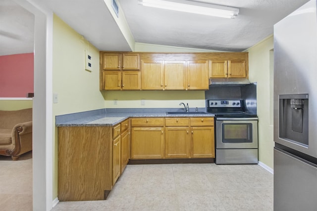 kitchen featuring light tile patterned flooring, stainless steel appliances, lofted ceiling, and sink