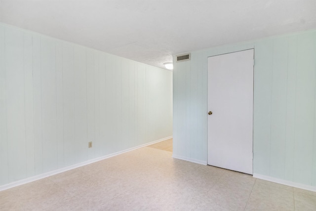 100 Spring St, Saint Augustine, FL 32084 - empty room with light flooring and wood walls
