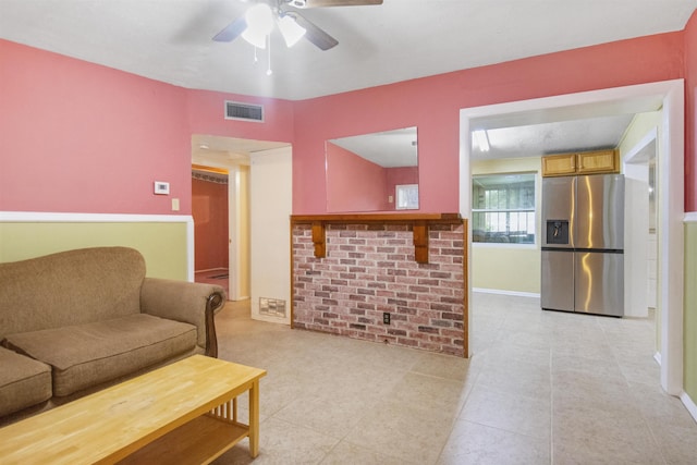 living room with light tile patterned floors and ceiling fan