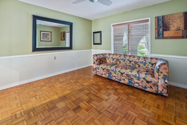 living area featuring parquet floors and ceiling fan