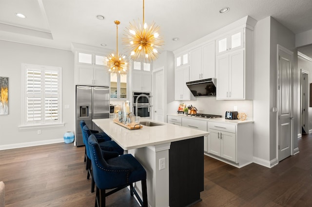 87 Amarante Ln, Saint Augustine, FL 32095 - kitchen featuring appliances with stainless steel finishes, baseboards, dark wood-style floors, recessed lighting, and a center island with sink