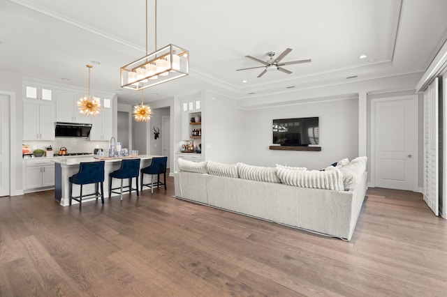 87 Amarante Ln, Saint Augustine, FL 32095 - living room with wood finished floors, a ceiling fan, recessed lighting, a raised ceiling, and crown molding