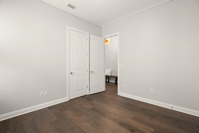 87 Amarante Ln, Saint Augustine, FL 32095 - unfurnished bedroom featuring crown molding, dark wood-type flooring, and baseboards