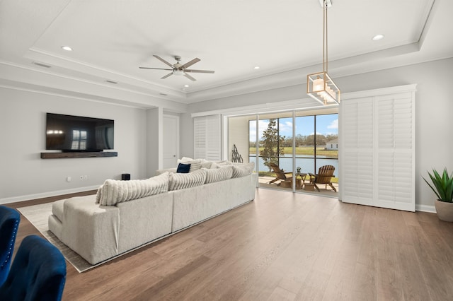87 Amarante Ln, Saint Augustine, FL 32095 - living area featuring a tray ceiling, recessed lighting, ceiling fan, crown molding, and wood finished floors