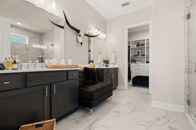 87 Amarante Ln, Saint Augustine, FL 32095 - bathroom featuring a marble finish shower, vanity, marble finish flooring, a spacious closet, and baseboards