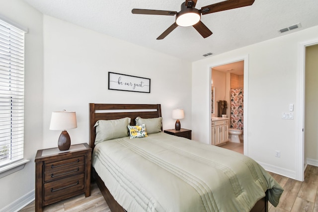 82 Lone Cypress Way, Saint Augustine, FL 32092 - bedroom featuring light wood finished floors, ensuite bath, and ceiling fan