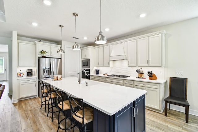 82 Lone Cypress Way, Saint Augustine, FL 32092 - kitchen featuring stainless steel appliances, custom range hood, tasteful backsplash, light wood-style floors, and light countertops