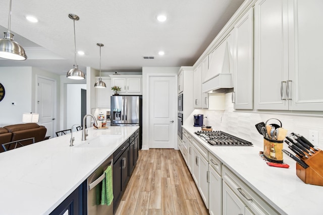 82 Lone Cypress Way, Saint Augustine, FL 32092 - kitchen featuring stainless steel appliances, recessed lighting, light wood-type flooring, custom range hood, and white cabinetry