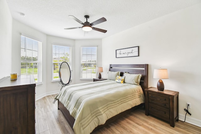 82 Lone Cypress Way, Saint Augustine, FL 32092 - bedroom featuring light wood-style flooring, ceiling fan, and a textured ceiling