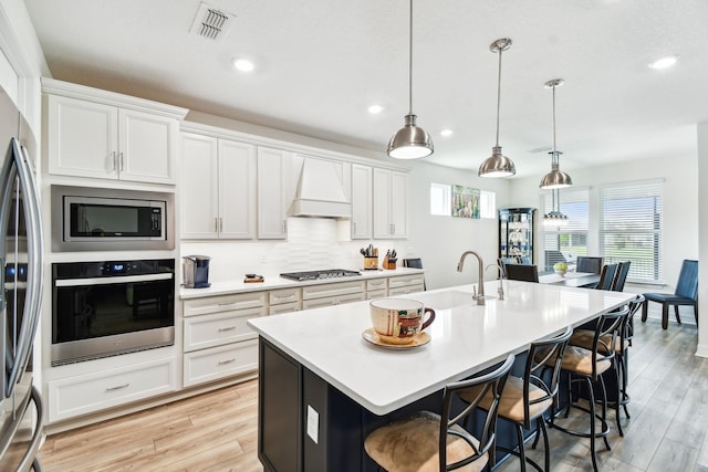 82 Lone Cypress Way, Saint Augustine, FL 32092 - kitchen featuring stainless steel appliances, a kitchen bar, plenty of natural light, and recessed lighting