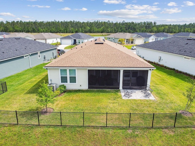 82 Lone Cypress Way, Saint Augustine, FL 32092 - back of property featuring a sunroom, a residential view, a fenced backyard, and a shingled roof