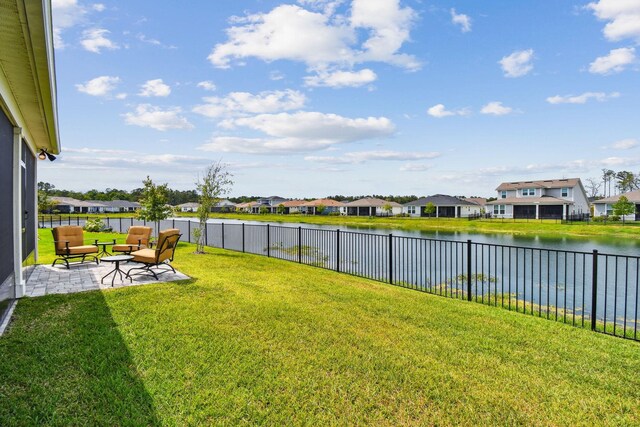 82 Lone Cypress Way, Saint Augustine, FL 32092 - fenced backyard with a residential view, a water view, a patio, and an outdoor living space