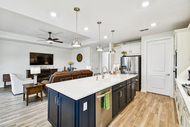 82 Lone Cypress Way, Saint Augustine, FL 32092 - kitchen with appliances with stainless steel finishes, light wood finished floors, ceiling fan, a kitchen island with sink, and light countertops