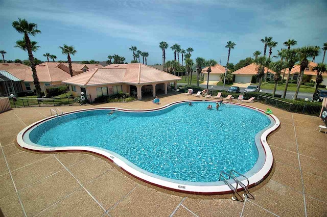 pool featuring a patio and fence