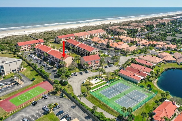 bird's eye view with a view of the beach, a water view, and a residential view