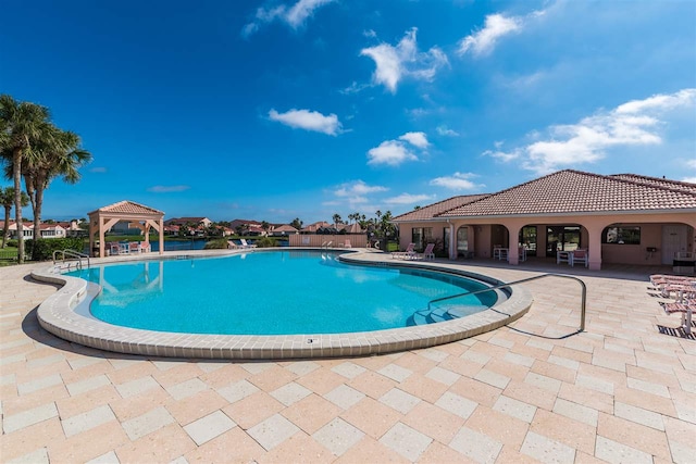 pool with a gazebo and a patio area