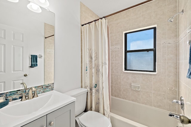 bathroom featuring toilet, shower / bath combo, and vanity