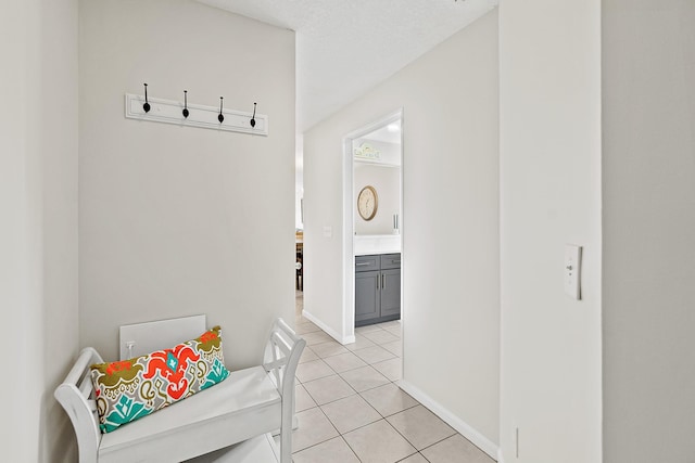 interior space with light tile patterned floors and baseboards