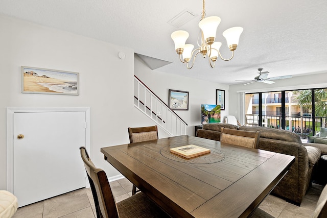 dining space with visible vents, stairs, ceiling fan with notable chandelier, light tile patterned flooring, and a textured ceiling