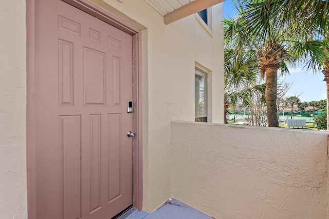 doorway to property with stucco siding