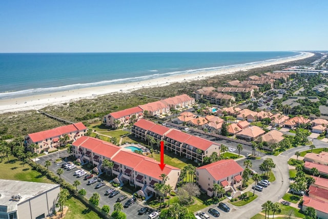 birds eye view of property with a view of the beach and a water view