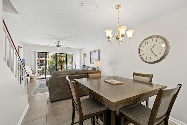 dining area featuring visible vents, baseboards, ceiling fan with notable chandelier, light tile patterned flooring, and a textured ceiling