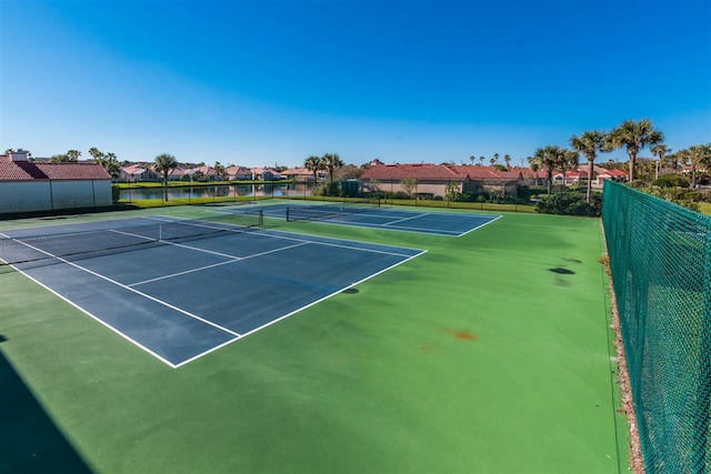 view of sport court featuring fence and a residential view