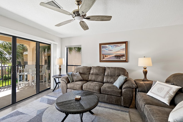 living room featuring a textured ceiling and a ceiling fan