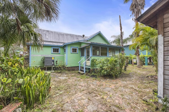 back of house featuring central AC and a sunroom