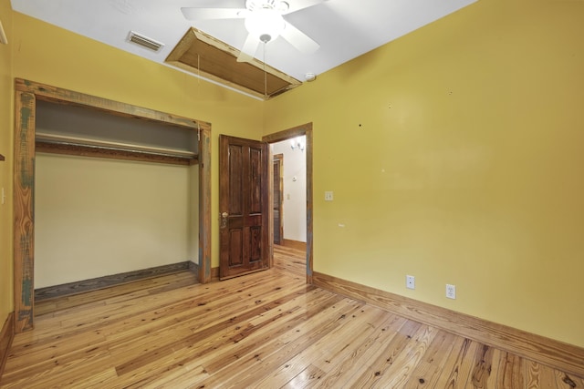 unfurnished bedroom featuring a closet, light hardwood / wood-style floors, and ceiling fan