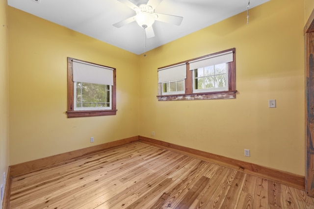 empty room with ceiling fan and light hardwood / wood-style floors