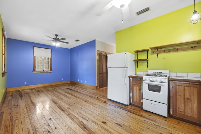 kitchen with ceiling fan, pendant lighting, white appliances, and light hardwood / wood-style floors