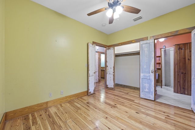 unfurnished bedroom featuring a closet, light hardwood / wood-style floors, and ceiling fan