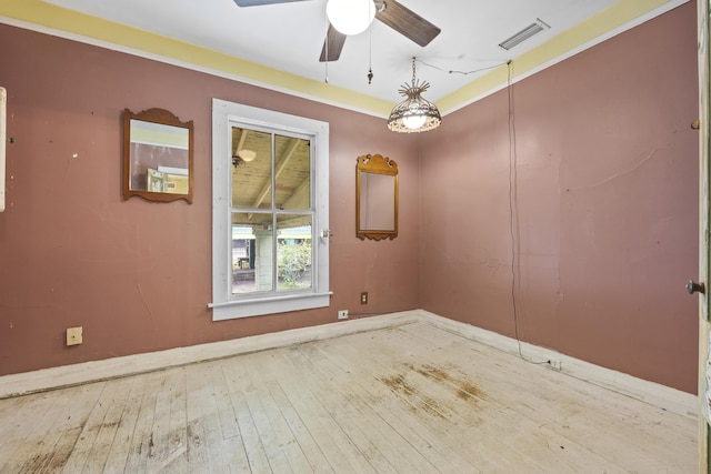 empty room featuring wood-type flooring and ceiling fan