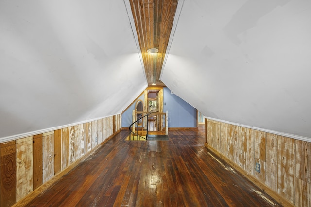 additional living space with dark hardwood / wood-style floors and lofted ceiling