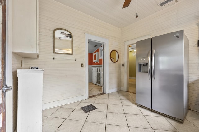 kitchen featuring stainless steel refrigerator with ice dispenser, light tile patterned floors, and ceiling fan