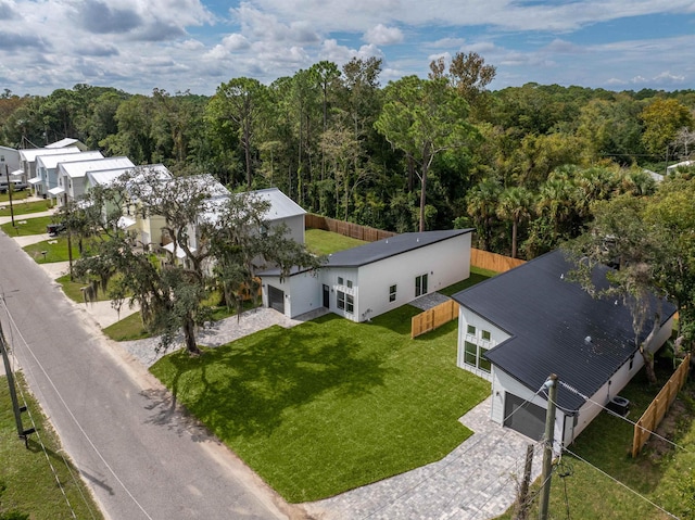 drone / aerial view featuring a wooded view