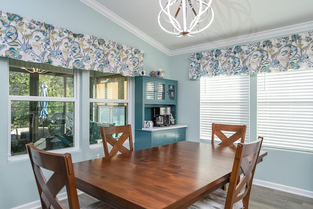 dining room with a notable chandelier, ornamental molding, dark wood-type flooring, and lofted ceiling