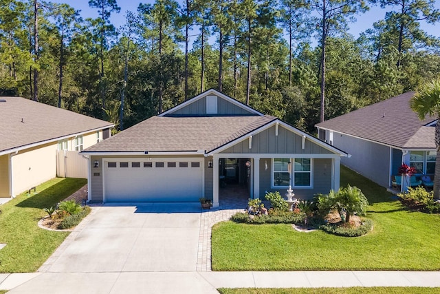 view of front of home with a front yard and a garage